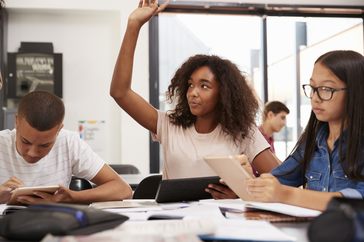 Student raising her hand in class
